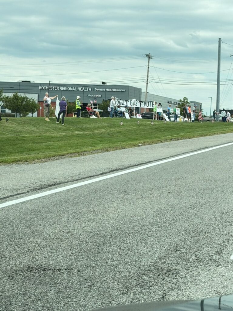 Protesters with signs outside Rochester Regional Health Geneseo campus