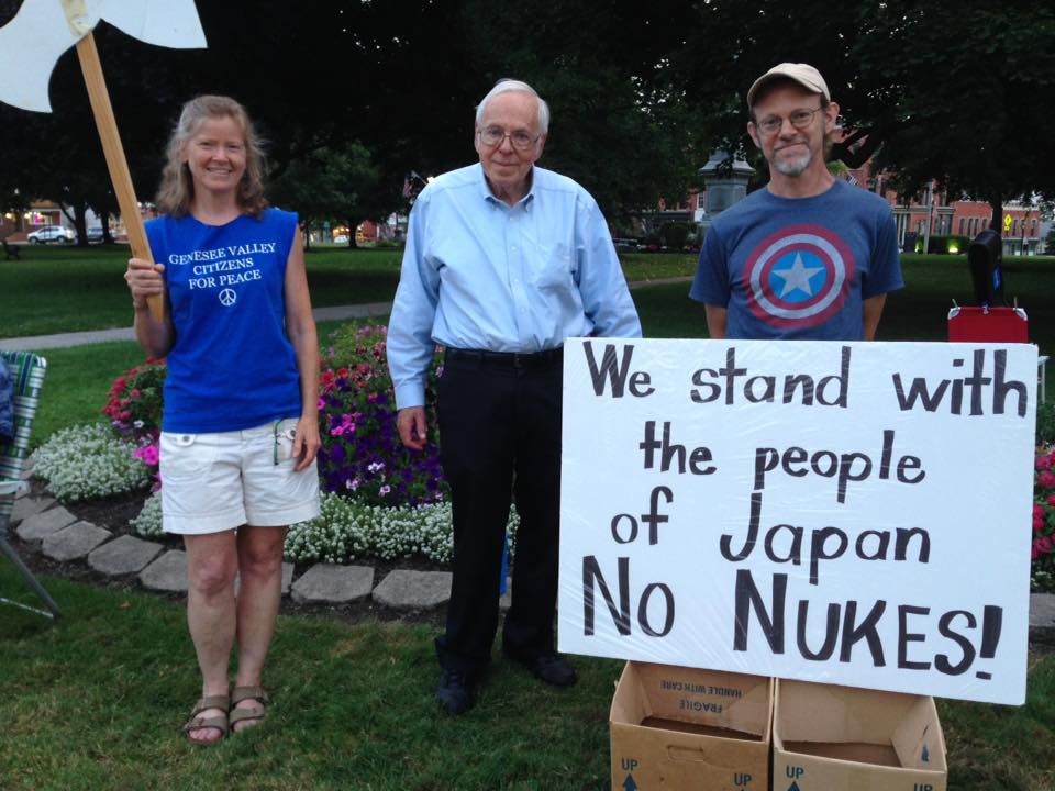 peaceful protesters with a sign that said We stand with the people of Japan, NO NUKES