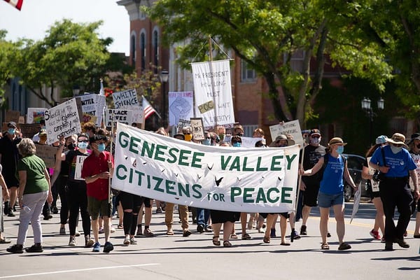 marchers with GVCP Banner in Geneseo, NY