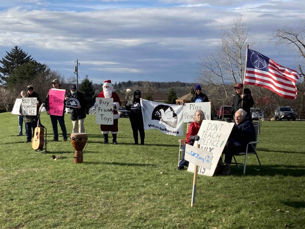 Group with signs saying don't buy war toys