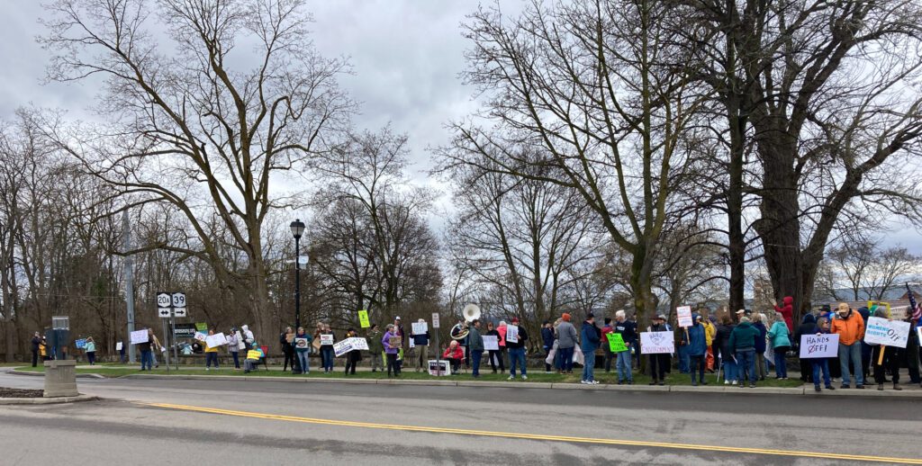 Hands off rally-goers with signs in Geneseo
